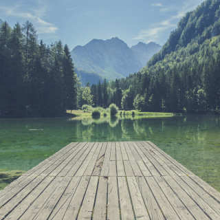 Dock on a peaceful lake with a mountain background