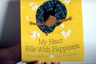 'My Heart Fills With Happiness' book held by author Monique Gray Smith