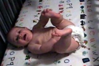 A 6.5 month old infant babbling in his crib.